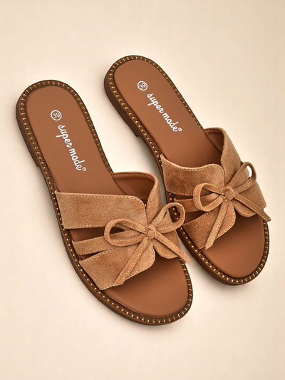 Royal Fashion women's flat slippers with a bow.