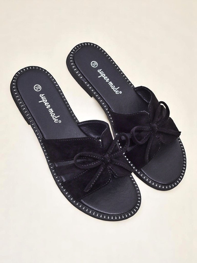 Women's flat slide sandals with a bow.