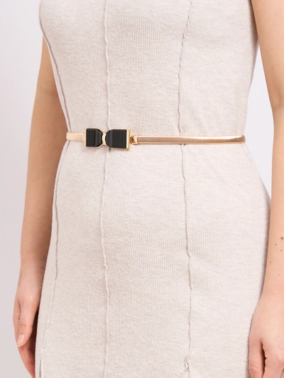 Golden women's Livia belt with a metal bow buckle in the Romano style