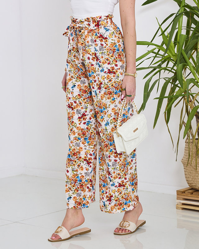 Naiste valged palazzo püksid oranžide lilledega- Rõivad