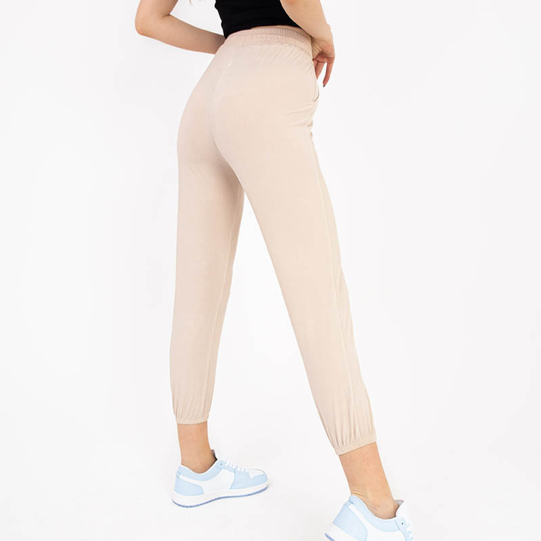 Beige women's fabric pants with a patch - Clothing