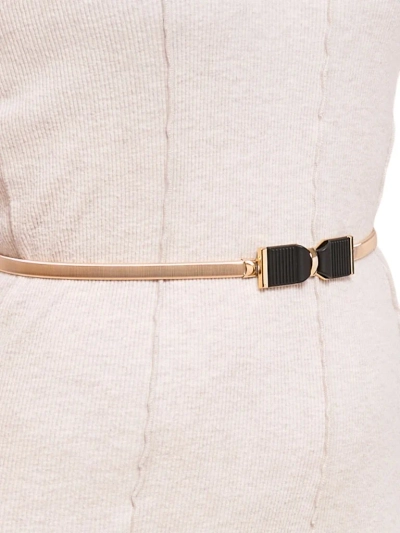 Golden women's Livia belt with a metal bow buckle in the Romano style