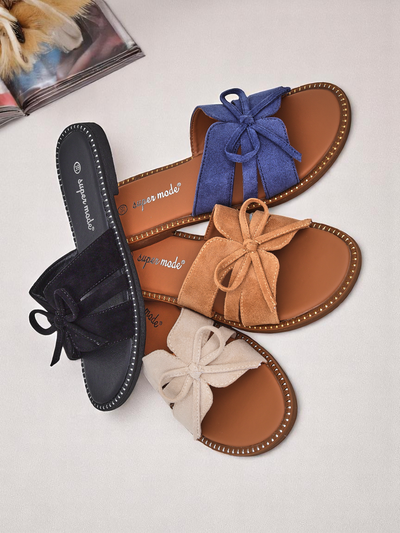 Royal Fashion women's flat slippers with a bow.