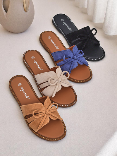 Royal Fashion women's flat slippers with a bow.