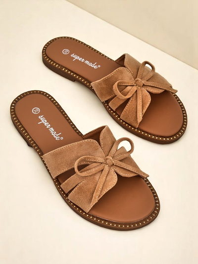 Royal Fashion women's flat slippers with a bow.