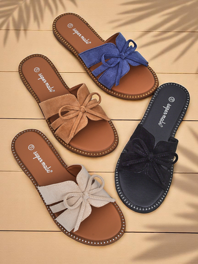 Women's flat slide sandals with a bow.