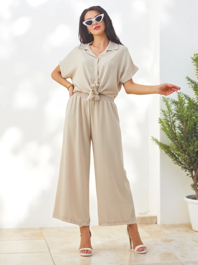 Royalfashion Naisten asu, jossa on sidottu lyhythihainen paita ja levenevät housut strasseilla