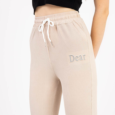 Beige women's fabric pants with a patch - Clothing